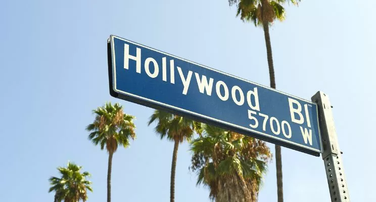 Hollywood Blvd sign with palm trees in the background